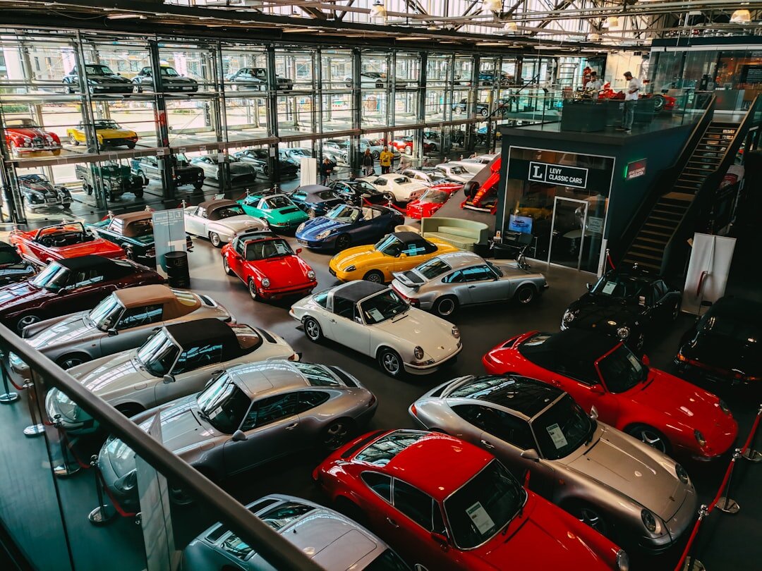 Rare vintage automobile displayed on a pedestal at an auction hall