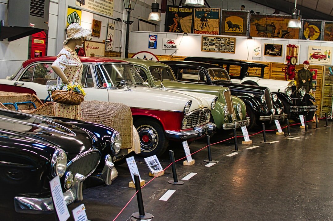 Interior of a classic car museum with vintage automobiles on display
