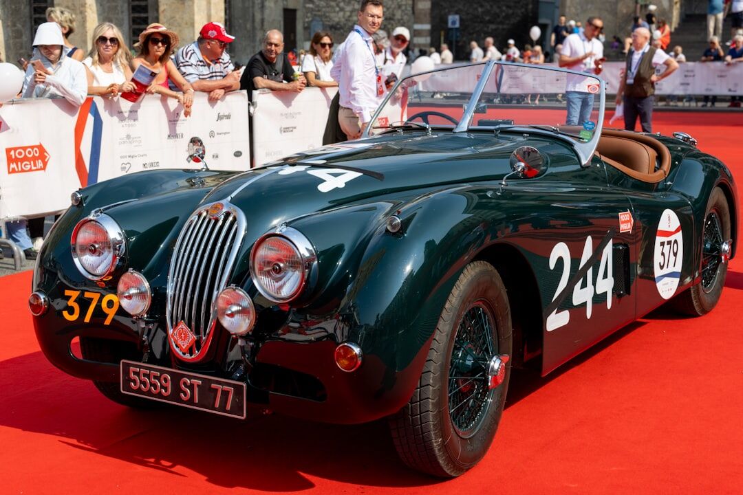 Restored vintage Jaguar-style roadster at an evening auction preview