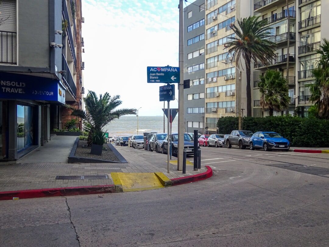 Classic convertible driving along the Rambla of Montevideo at dusk